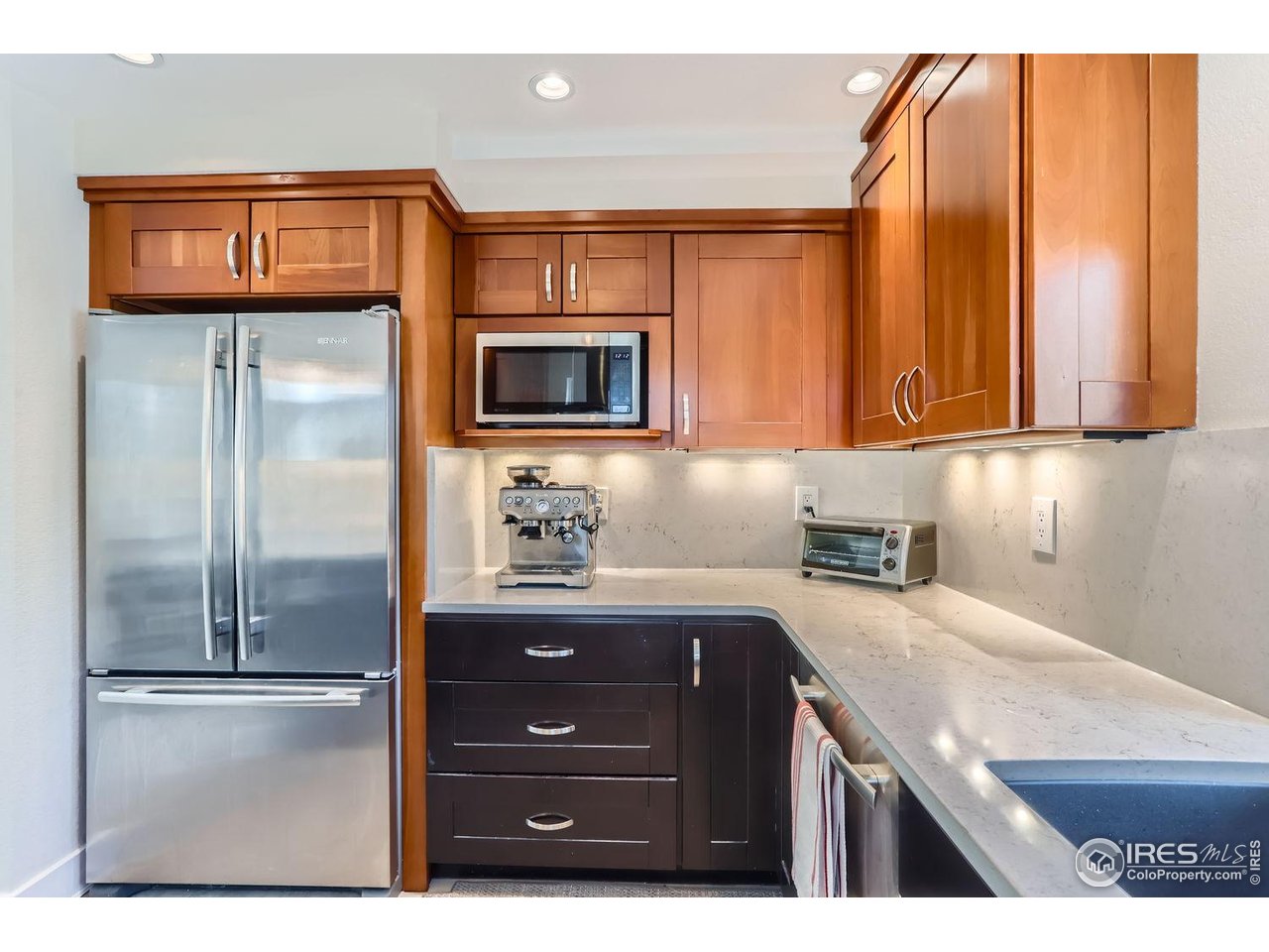 620 Pearl Street, Unit E Boulder, CO 80302 - Photo 7 of 37 a kitchen with granite countertop stainless steel appliances and wooden cabinets