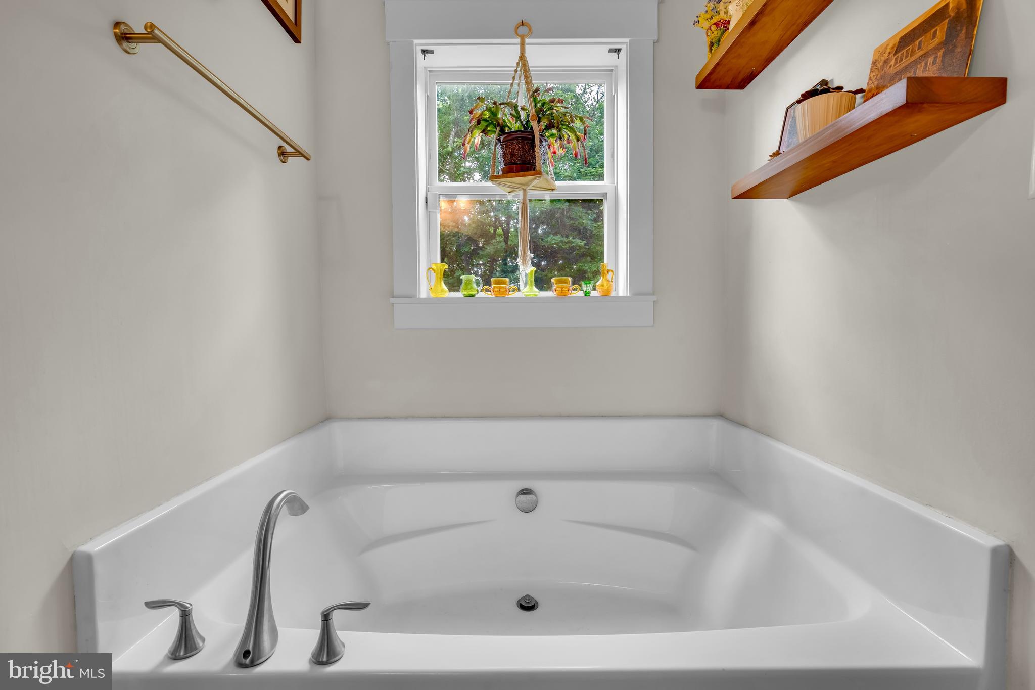 321 Front Street Crumpton, MD 21628 - Photo 22 of 59 a white bath tub sitting in a bathroom next to a window
