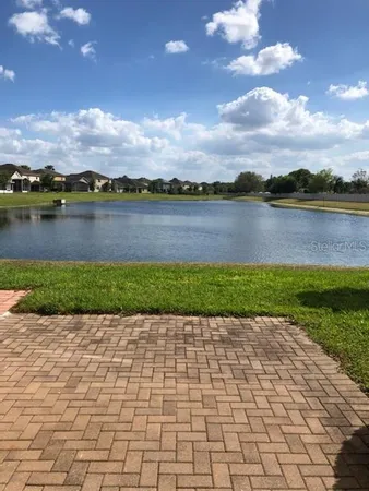a front view of a house with a garden and trees