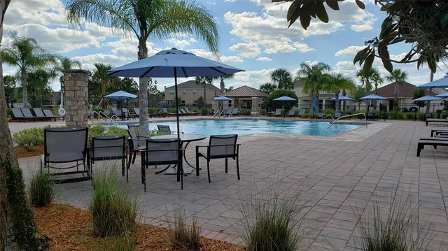 a swimming pool with outdoor seating and yard