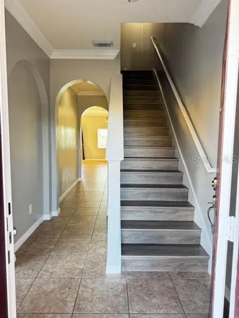 a view of entryway and hall with wooden floor