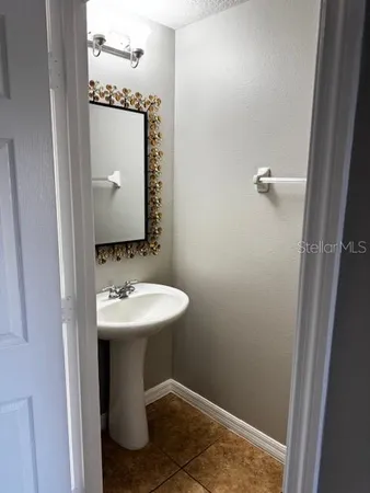 a bathroom with a sink and mirror