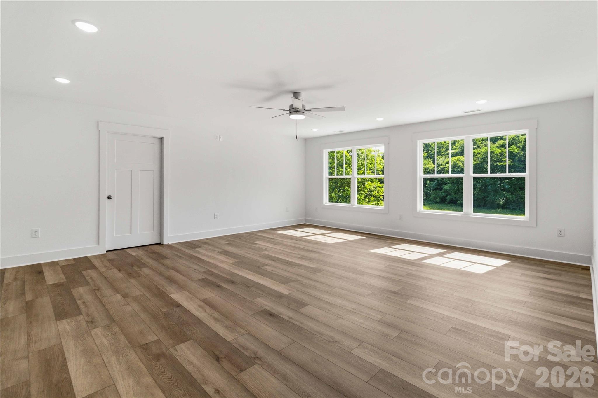 352 Adams Road Clover, SC 29710 - Photo 23 of 38 an empty room with wooden floor and windows
