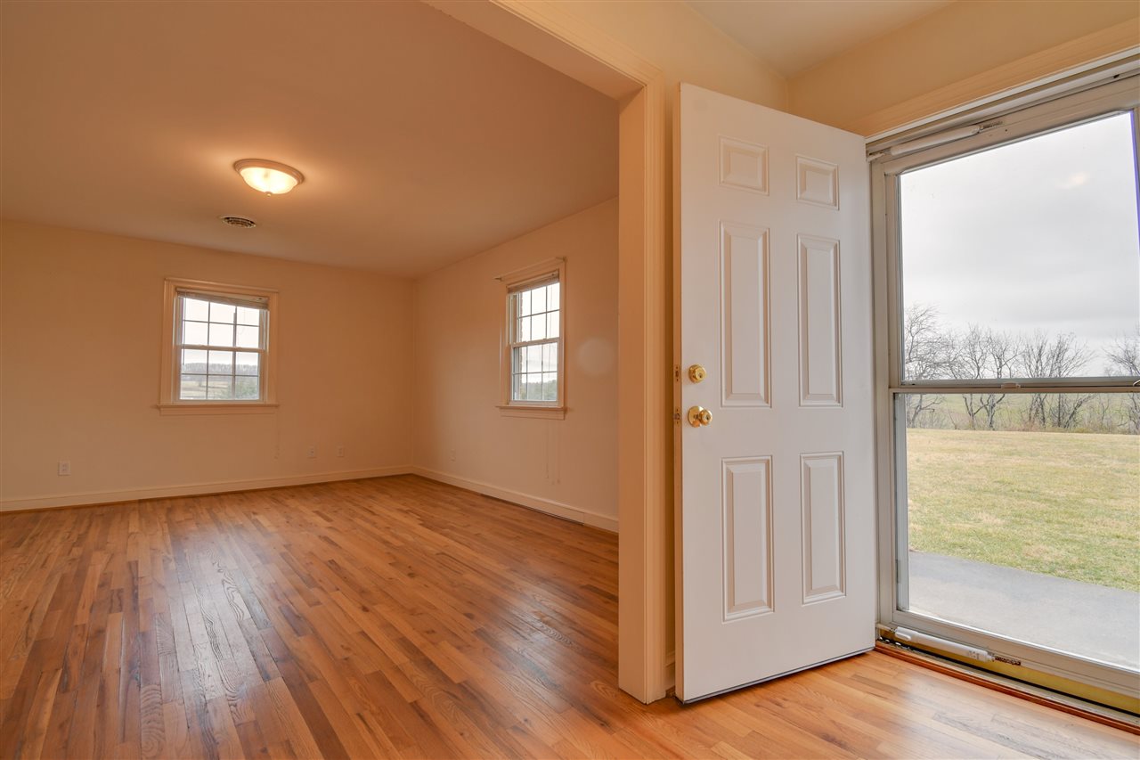 2041 Barterbrook Road Staunton, VA 24401 - Photo 3 of 30 a view of an empty room with glass door and wooden floor