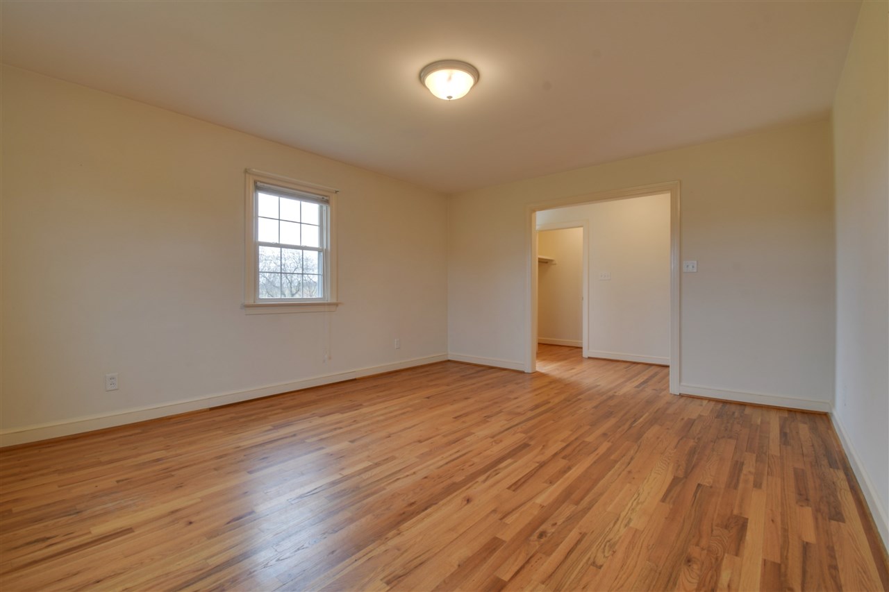2041 Barterbrook Road Staunton, VA 24401 - Photo 8 of 30 a view of an empty room with wooden floor and a window