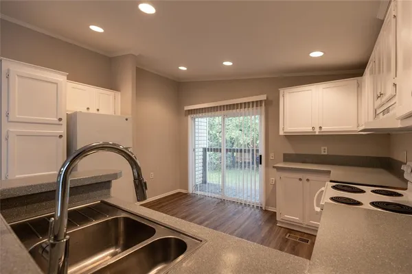 a kitchen with a stove a sink and a window