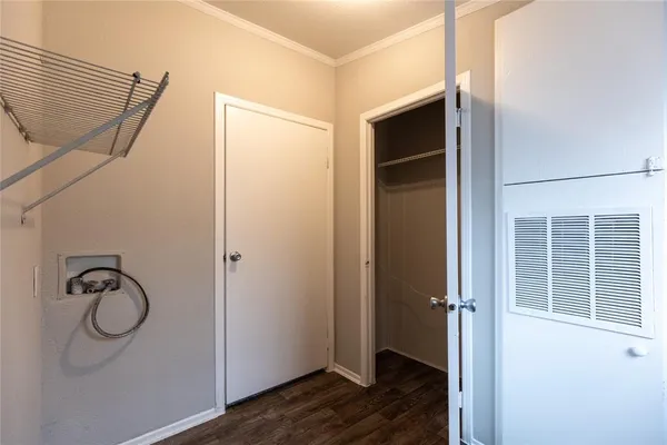a view of a room with wooden floor and mirror