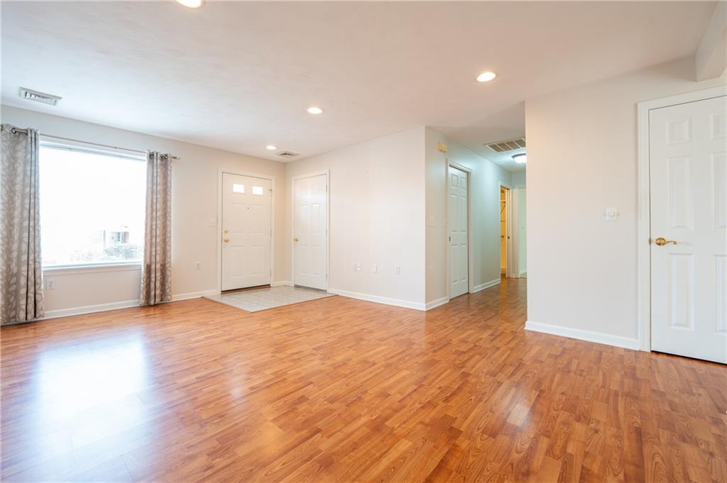 1468 Spring Crest Circle Latrobe, PA 15650 - Photo 5 of 30 a view of an empty room with wooden floor and a window