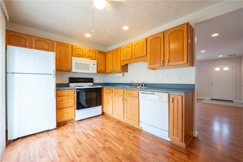 1468 Spring Crest Circle Latrobe, PA 15650 - Photo 7 of 30 a kitchen with stainless steel appliances granite countertop a refrigerator a sink and a stove