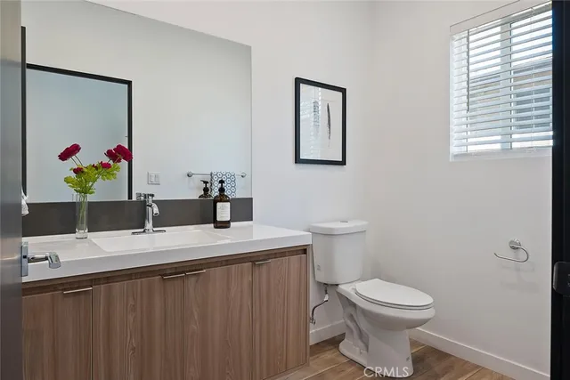 a bathroom with a sink vanity mirror and toilet