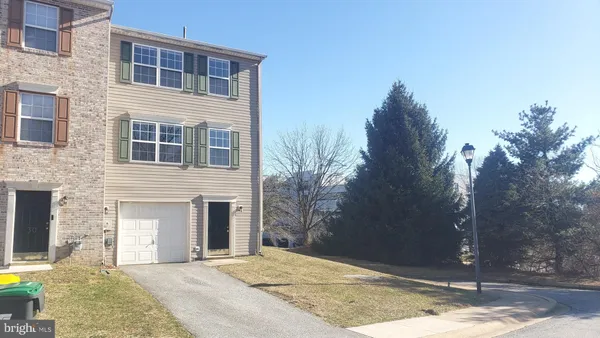 a view of a house with snow on the road
