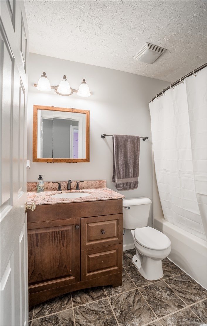 1442 Langdon Road Sidney, OH 45365 - Photo 13 of 34 Functional full bathroom featuring a vanity with granite counters and tiled flooring.