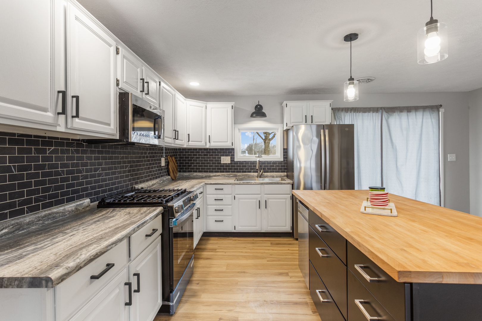 402 South Washington Street Saybrook, IL 61770 - Photo 11 of 24 a kitchen with granite countertop a sink stove and refrigerator
