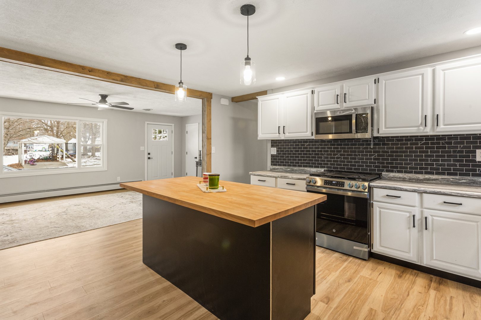 402 South Washington Street Saybrook, IL 61770 - Photo 12 of 24 a kitchen with stainless steel appliances granite countertop a sink a stove and a wooden floors
