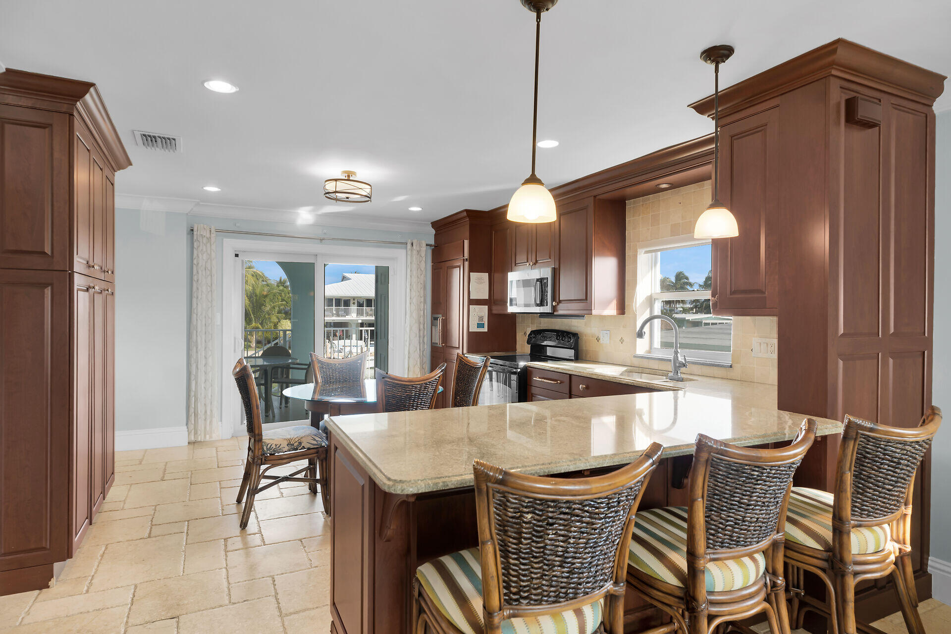 580-590 10th Street Key Colony Beach, FL 33051 - Photo 48 of 75 a dining area with a table chairs and a kitchen view