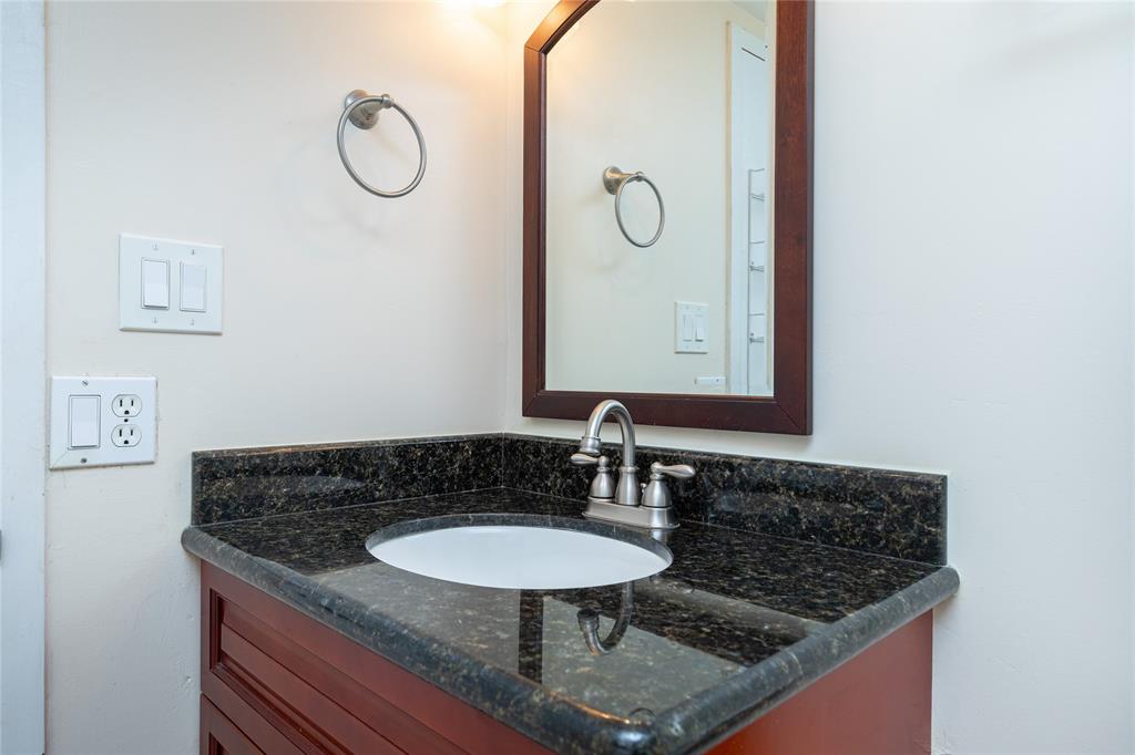5300 Northeast 24th Terrace, Unit 416C Fort Lauderdale, FL 33308 - Photo 14 of 26 a bathroom with a granite countertop sink and a mirror
