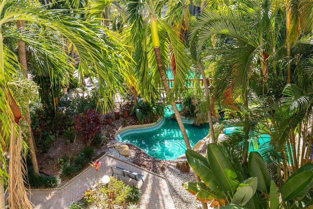5300 Northeast 24th Terrace, Unit 416C Fort Lauderdale, FL 33308 - Photo 15 of 26 a backyard of a house with a yard and outdoor seating