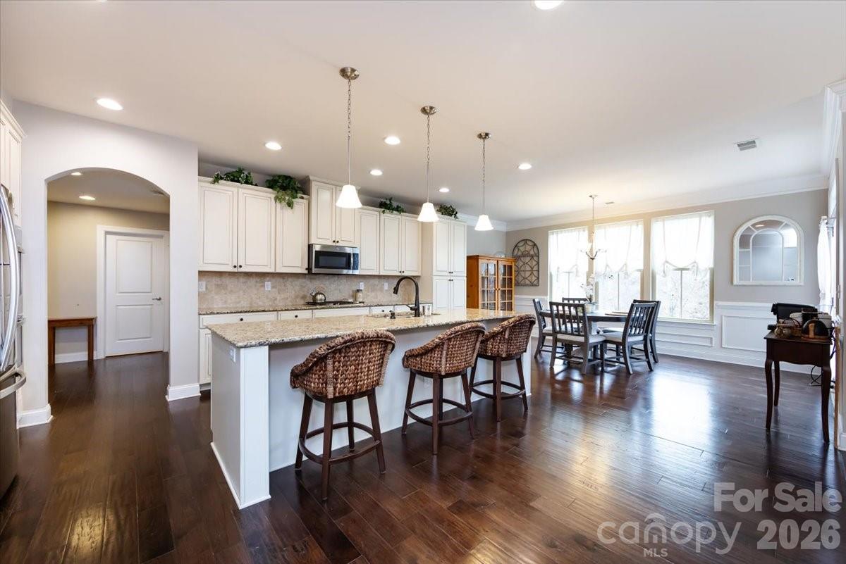 7335 Millstone Circle Southwest Concord, NC 28025 - Photo 13 of 40 an open kitchen with kitchen island and stainless steel appliances