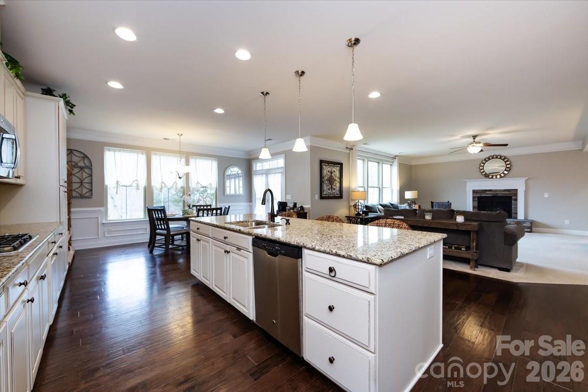 7335 Millstone Circle Southwest Concord, NC 28025 - Photo 14 of 40 a large kitchen with kitchen island lots of counter space a sink appliances and a living room view