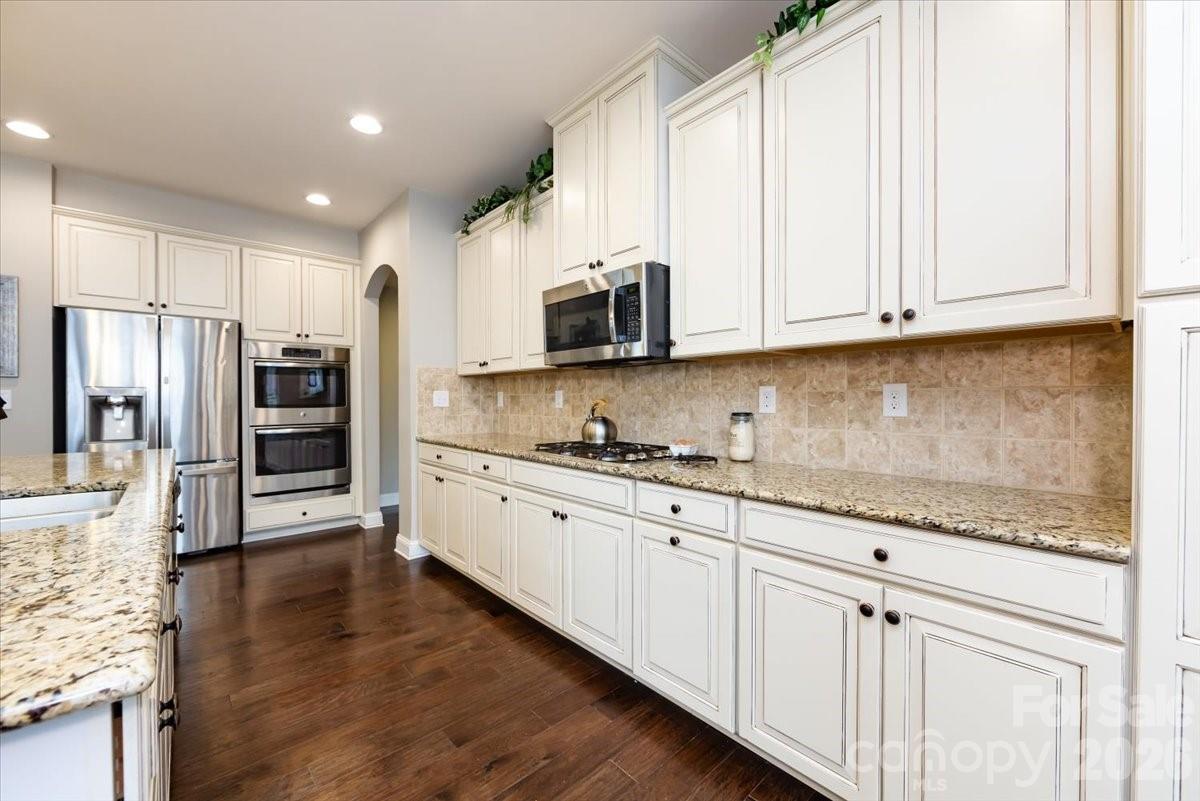 7335 Millstone Circle Southwest Concord, NC 28025 - Photo 16 of 40 a kitchen with stainless steel appliances granite countertop a refrigerator and cabinets