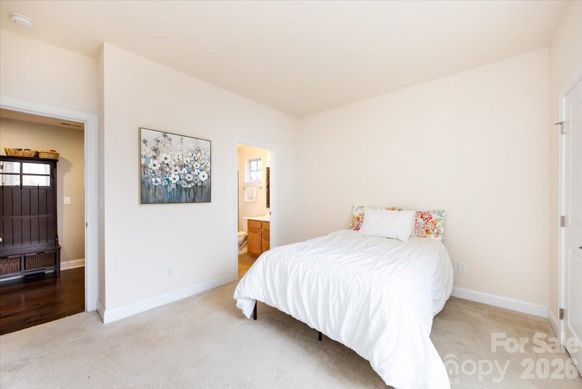 7335 Millstone Circle Southwest Concord, NC 28025 - Photo 18 of 40 a bedroom with a bed and a flat screen tv
