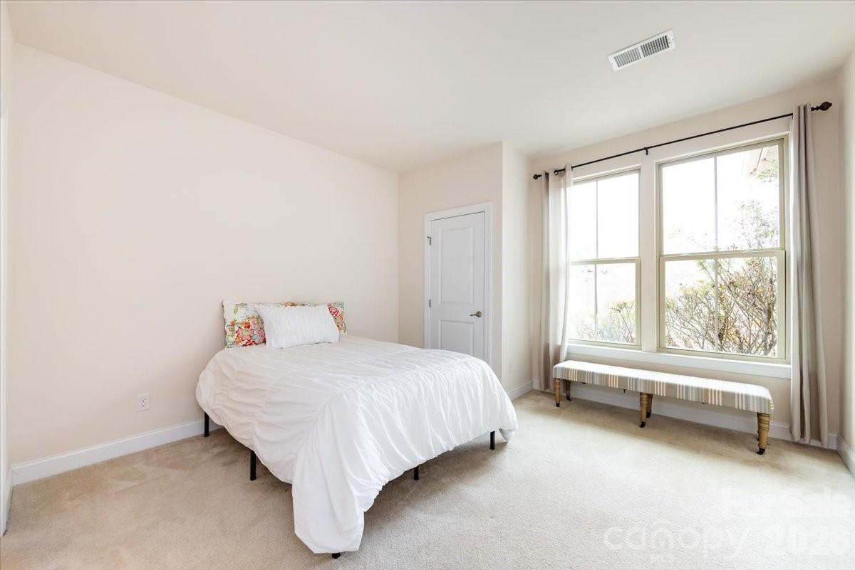 7335 Millstone Circle Southwest Concord, NC 28025 - Photo 19 of 40 a bed sitting in a room next to a window