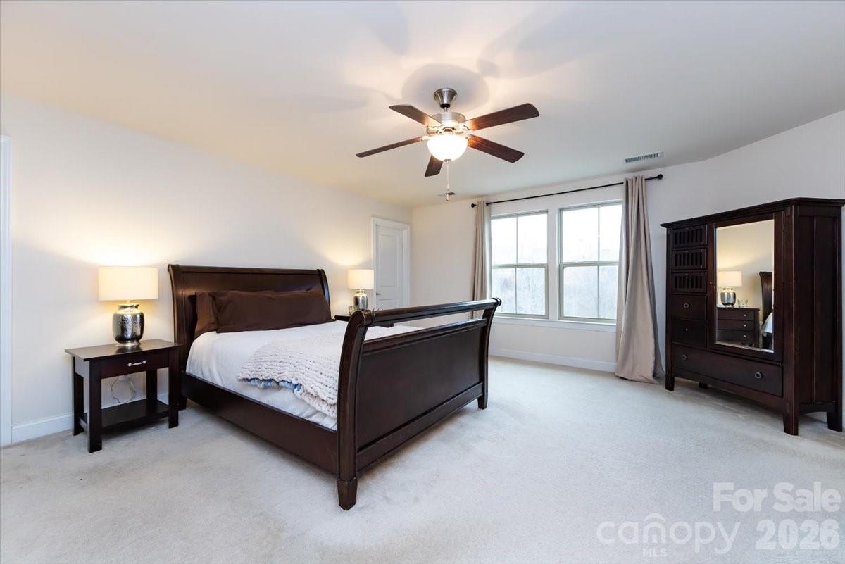 7335 Millstone Circle Southwest Concord, NC 28025 - Photo 25 of 40 a bedroom with a bed and a large window