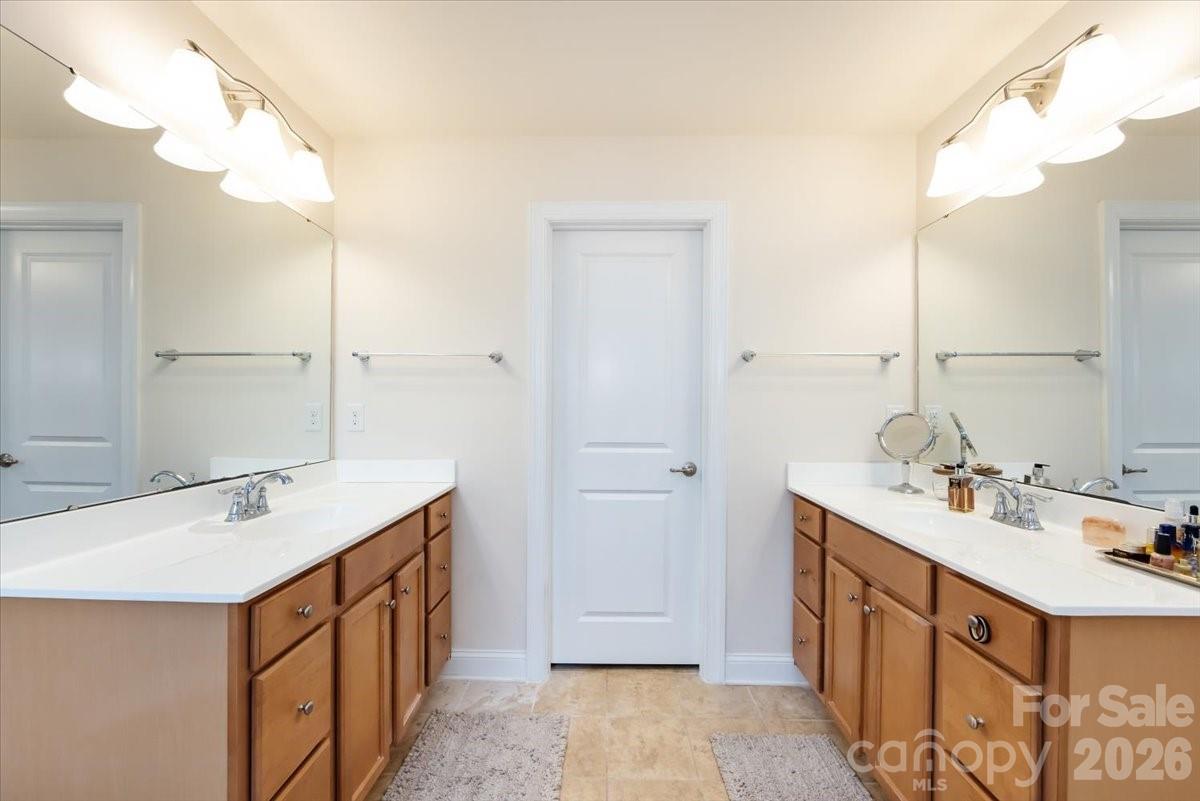 7335 Millstone Circle Southwest Concord, NC 28025 - Photo 27 of 40 a bathroom with a sink double vanity and a mirror