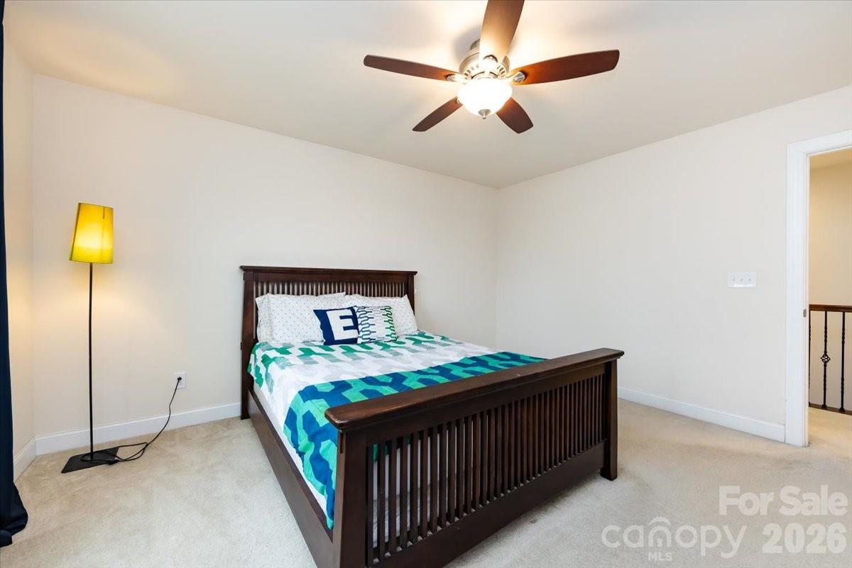 7335 Millstone Circle Southwest Concord, NC 28025 - Photo 29 of 40 a bedroom with a bed and a chandelier