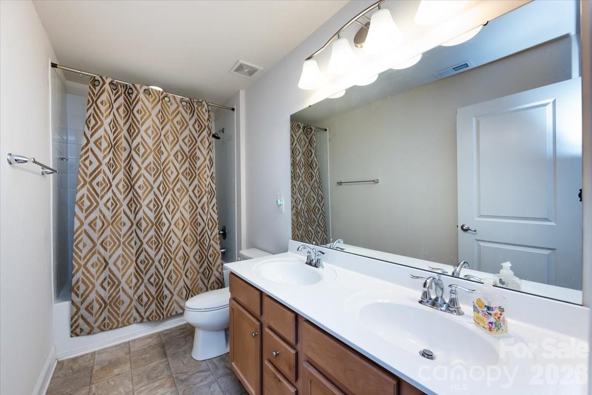 7335 Millstone Circle Southwest Concord, NC 28025 - Photo 30 of 40 a bathroom with a sink and a mirror