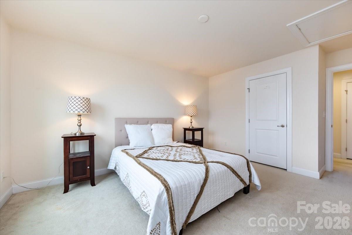7335 Millstone Circle Southwest Concord, NC 28025 - Photo 32 of 40 a bedroom with a bed and a lamp