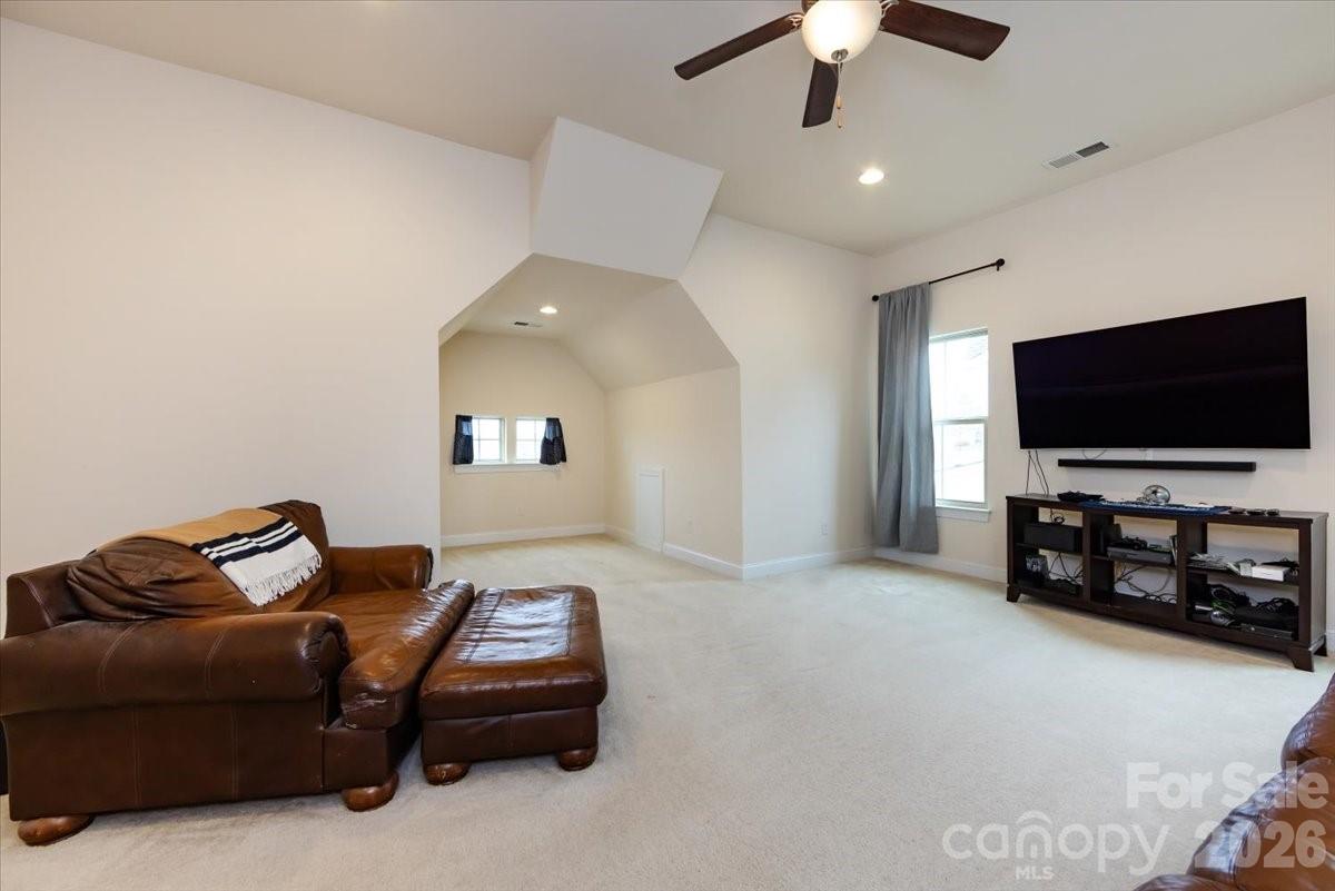 7335 Millstone Circle Southwest Concord, NC 28025 - Photo 34 of 40 a living room with furniture and a flat screen tv