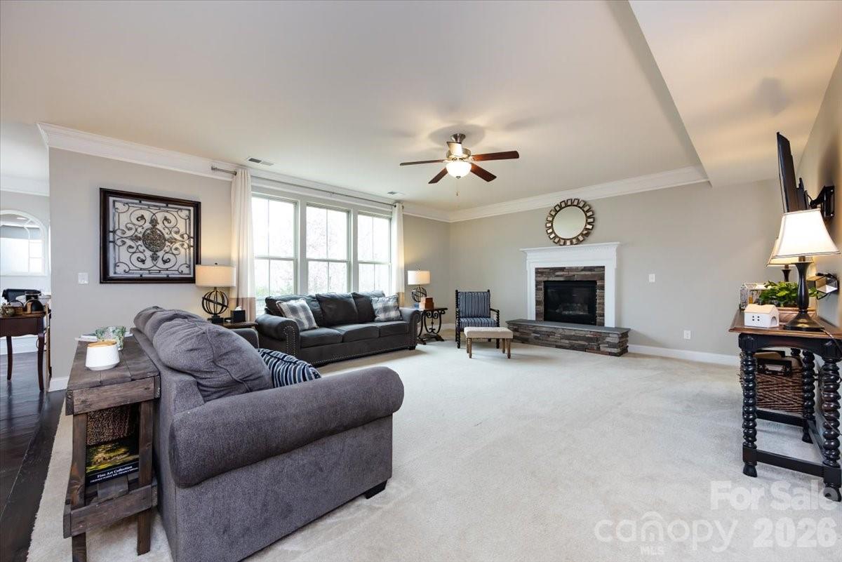 7335 Millstone Circle Southwest Concord, NC 28025 - Photo 8 of 40 a living room with furniture a fireplace and a flat screen tv