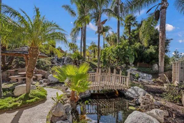 a living room with furniture a chandelier and a large window