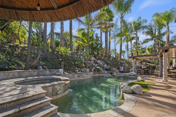 a kitchen with stainless steel appliances granite countertop a sink a stove and a wooden cabinets
