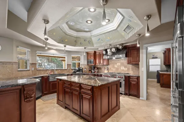 a kitchen with stainless steel appliances granite countertop a stove and a sink