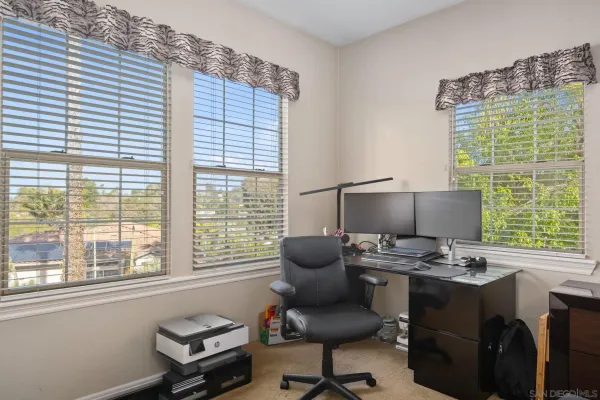 a bedroom with a bed a large window and a couch