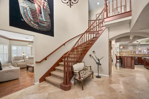 a view of hall way with furniture and bathroom