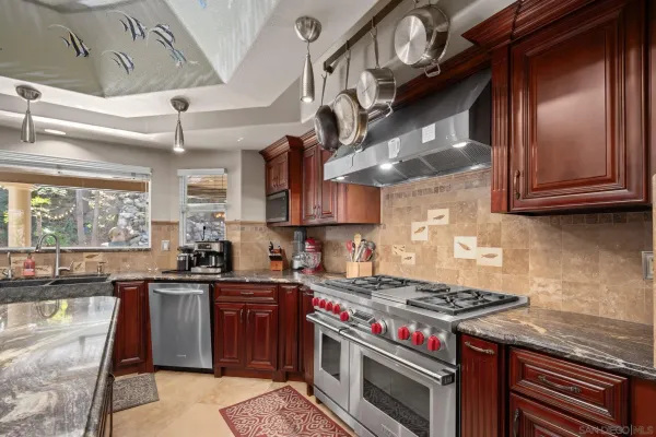 a kitchen with granite countertop a sink and a window