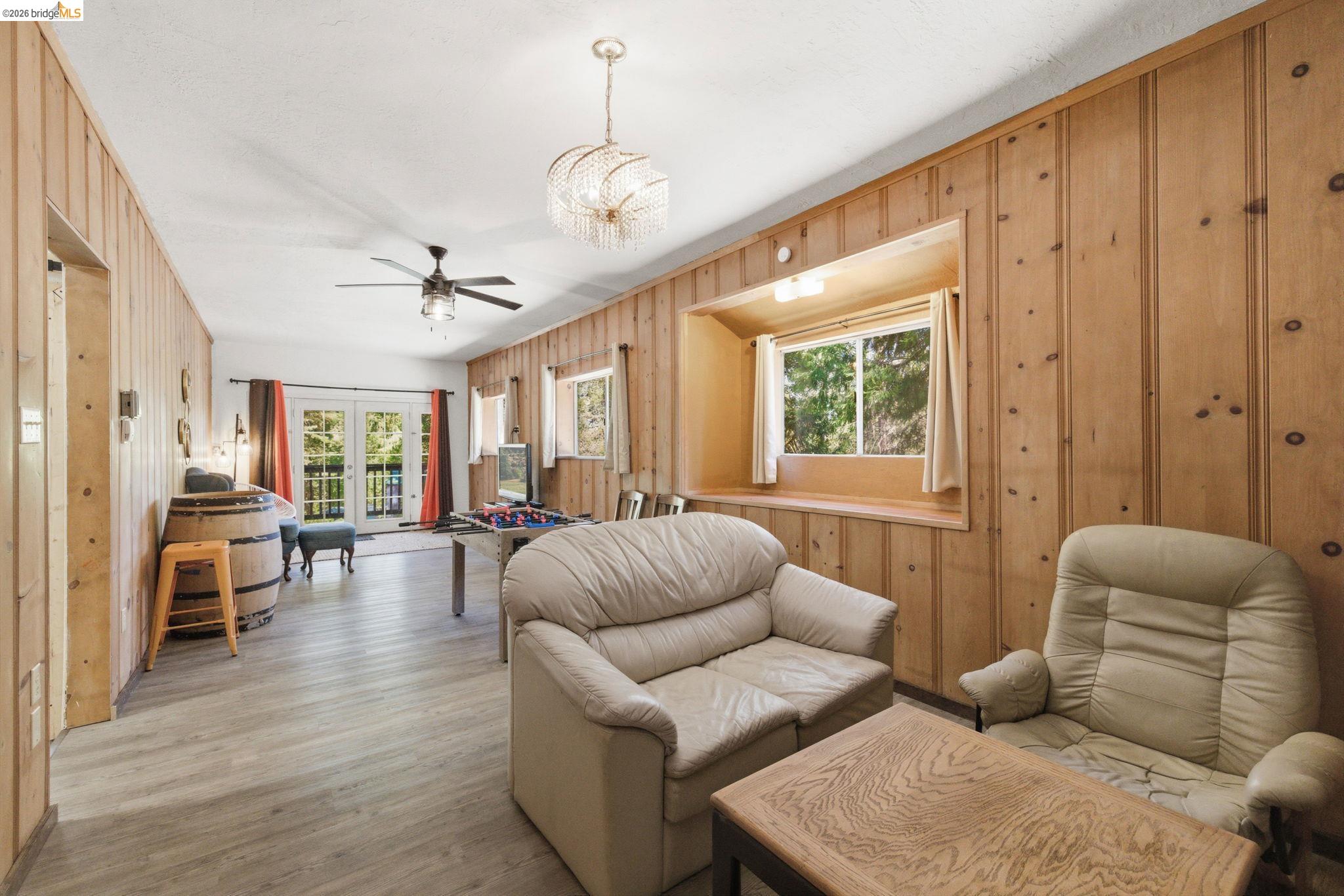 24189 South Fork Road Twain Harte, CA 95383 - Photo 15 of 34 a living room with furniture ceiling fan and a window