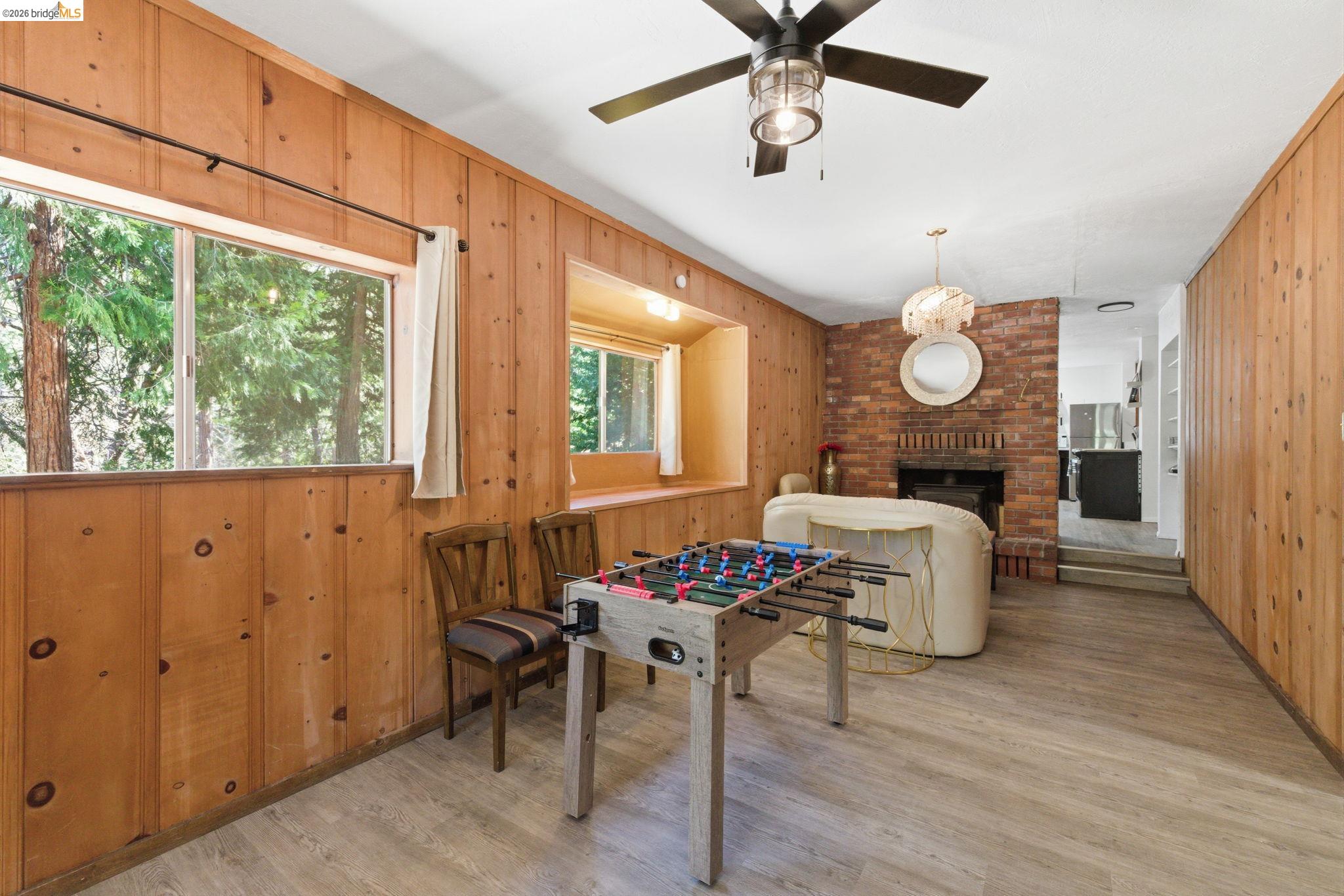 24189 South Fork Road Twain Harte, CA 95383 - Photo 16 of 34 a living room with furniture a dining table and a large window