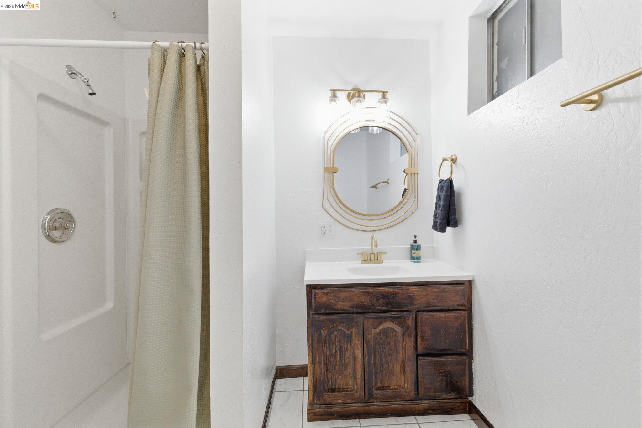 24189 South Fork Road Twain Harte, CA 95383 - Photo 24 of 34 a bathroom with a sink a mirror a toilet and a shower