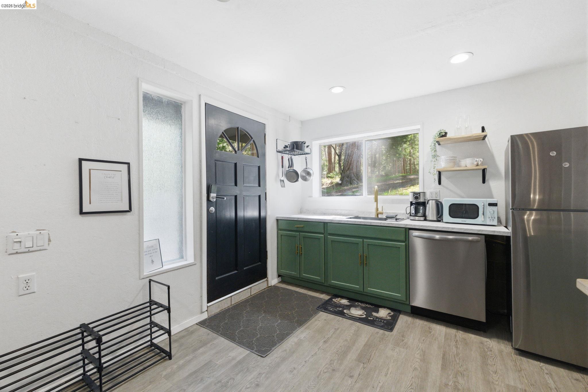 24189 South Fork Road Twain Harte, CA 95383 - Photo 33 of 34 a kitchen with a refrigerator and a sink