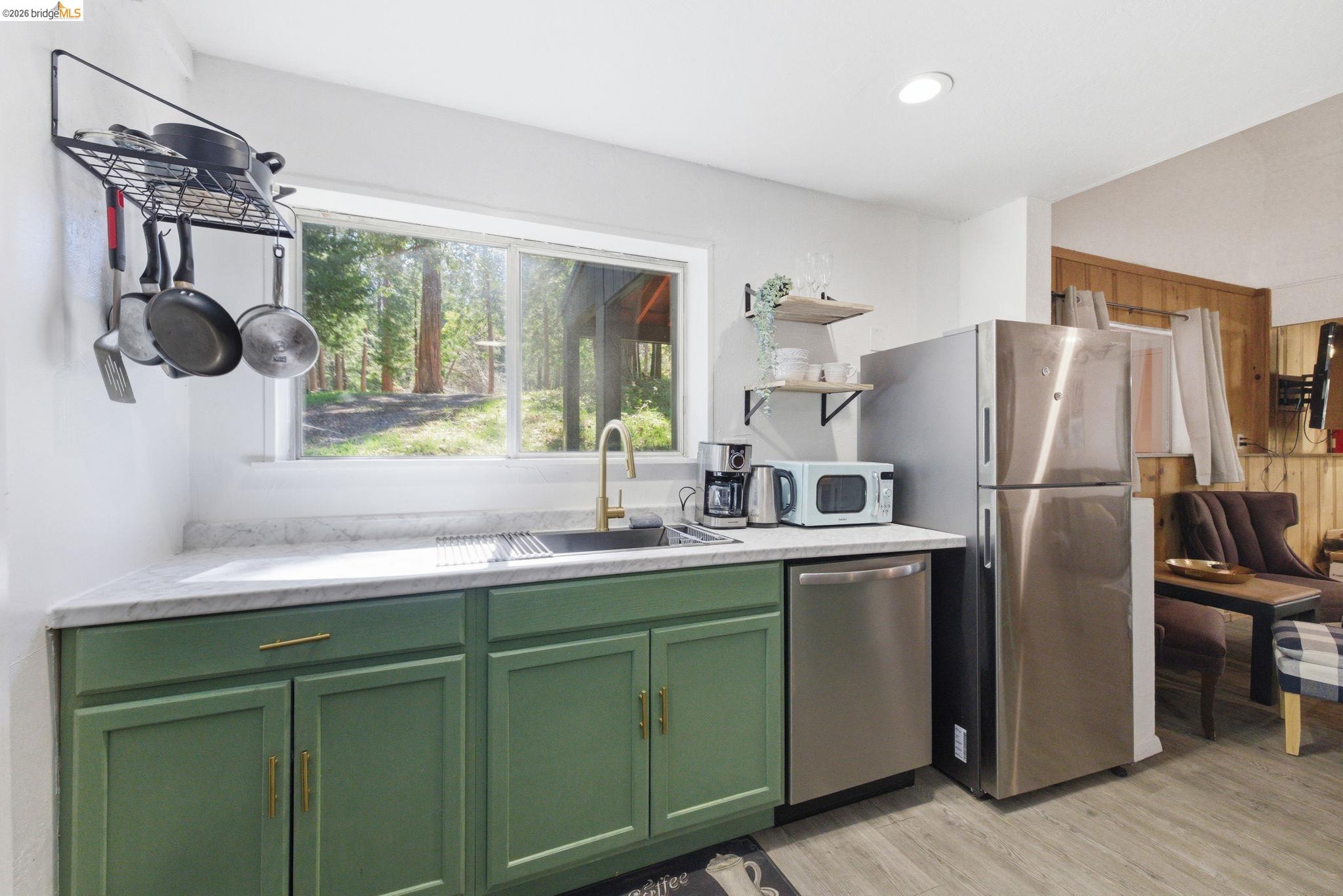 24189 South Fork Road Twain Harte, CA 95383 - Photo 6 of 34 a kitchen with stainless steel appliances a sink cabinets and a window