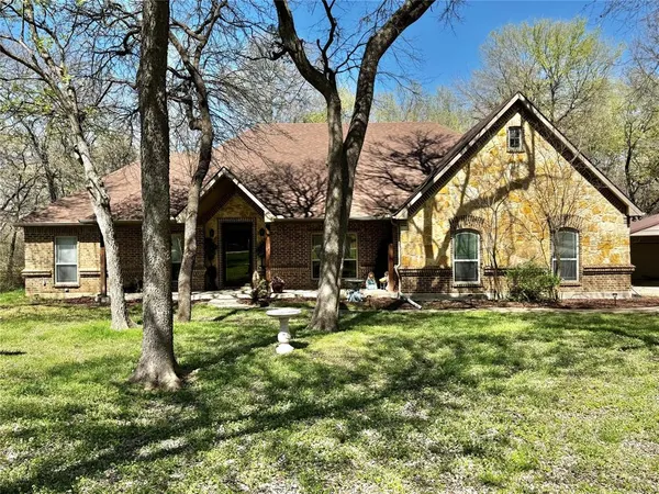 a view of a house with backyard porch and sitting area