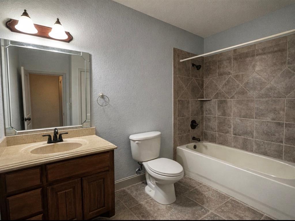 121 Rey Del Mar Circle Weatherford, TX 76085 - Photo 13 of 29 a bathroom with a sink toilet and shower