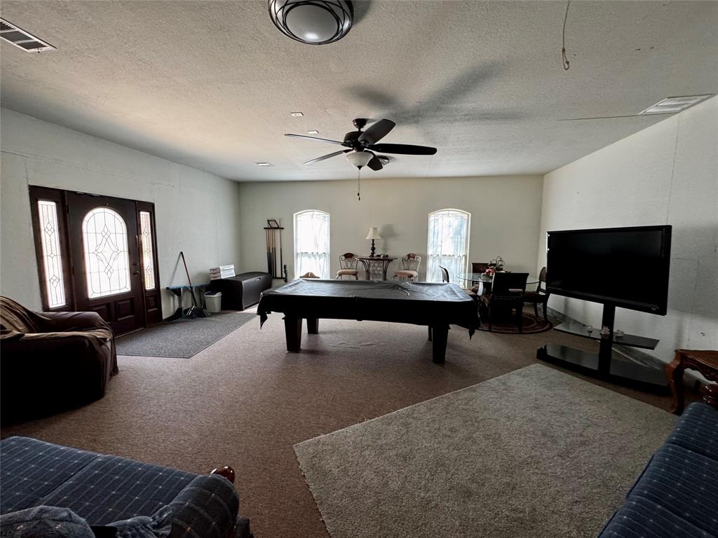 121 Rey Del Mar Circle Weatherford, TX 76085 - Photo 14 of 29 a living room with furniture and a flat screen tv