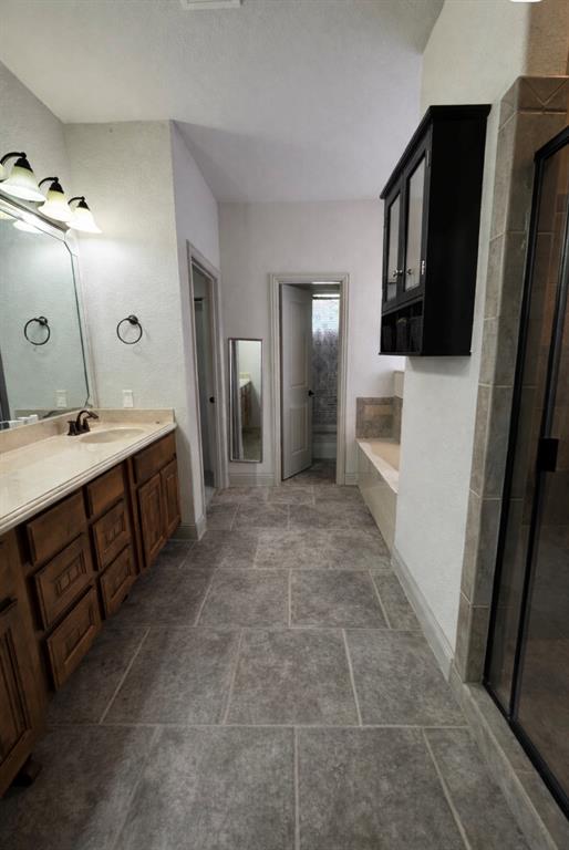 121 Rey Del Mar Circle Weatherford, TX 76085 - Photo 18 of 29 a bathroom with a sink a toilet and mirror