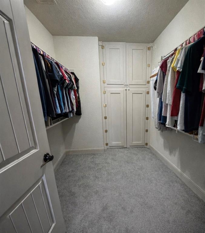 121 Rey Del Mar Circle Weatherford, TX 76085 - Photo 20 of 29 a view of walk in closet with clothes and shoes
