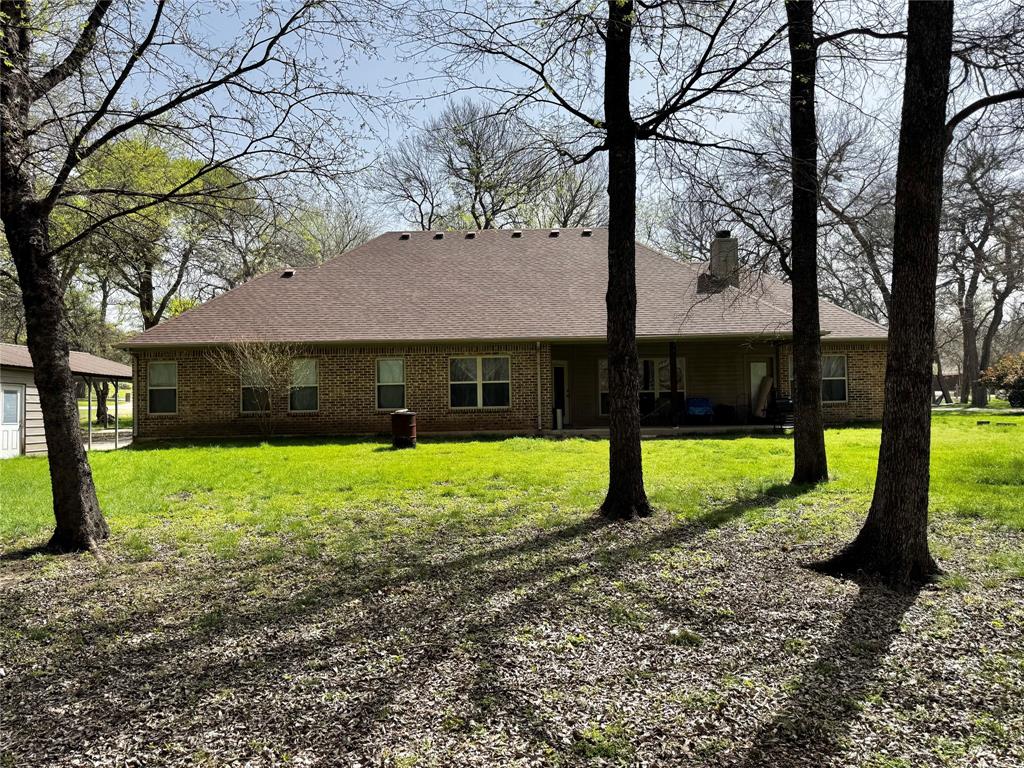 121 Rey Del Mar Circle Weatherford, TX 76085 - Photo 29 of 29 a view of a house with backyard and a tree